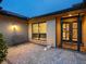Exterior with glass front door, brick-paved walkway, and exterior lighting and seating at 3905 Country View Dr, Sarasota, FL 34233