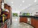 Bright kitchen featuring dark counter tops, a breakfast bar, stainless steel appliances, and views of the outdoors at 3905 Country View Dr, Sarasota, FL 34233