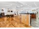 Bright living room boasts a fireplace, hardwood floors, and a seamless connection to the kitchen and bar area at 3905 Country View Dr, Sarasota, FL 34233