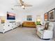 Bright living room with large television, ceiling fan, and modern furnishings provides a relaxing atmosphere at 3905 Country View Dr, Sarasota, FL 34233