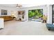 Relax in this living room and enjoy the view of the backyard through the large sliding glass doors at 3905 Country View Dr, Sarasota, FL 34233