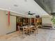 Inviting covered patio with tile flooring, ceiling fan, and comfortable seating area at 3905 Country View Dr, Sarasota, FL 34233