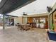 Covered patio area with tiled flooring, ceiling fan, and sliding glass doors to the indoor living space at 3905 Country View Dr, Sarasota, FL 34233