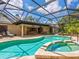 A screened pool area features a hot tub and patio, blending indoor comfort with outdoor enjoyment and unobstructed views at 3905 Country View Dr, Sarasota, FL 34233