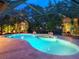 Outdoor pool area is screened-in, providing a secluded retreat surrounded by mature greenery for ultimate privacy and relaxation at 3905 Country View Dr, Sarasota, FL 34233