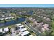An elevated view of the real estate complex and nearby lake, enhanced by lush greenery and mature trees at 3919 Glen Oaks Manor Dr, Sarasota, FL 34232