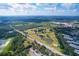 Expansive aerial view showcases the lush golf course, adjacent to the community's beautiful green landscape at 3919 Glen Oaks Manor Dr, Sarasota, FL 34232