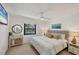 Cozy bedroom with a queen bed, decorative pillows, and a stylish vanity with a round mirror at 3919 Glen Oaks Manor Dr, Sarasota, FL 34232