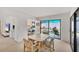 Carpeted dining area with table and chairs, and sliding glass doors opening to the outdoor patio at 3919 Glen Oaks Manor Dr, Sarasota, FL 34232