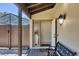 Covered entryway with stone floor, outdoor lighting, and a bench at 3919 Glen Oaks Manor Dr, Sarasota, FL 34232