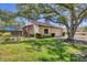 Well-manicured lawn and shade trees enhance the curb appeal of this home at 3919 Glen Oaks Manor Dr, Sarasota, FL 34232