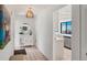 Hallway boasts neutral walls, tile flooring, light fixture and views into the kitchen at 3919 Glen Oaks Manor Dr, Sarasota, FL 34232