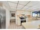 Bright kitchen featuring neutral cabinetry, stainless steel appliances, and a view to adjacent seating area at 3919 Glen Oaks Manor Dr, Sarasota, FL 34232