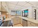 Kitchen with stainless steel appliances and sink overlooking the patio area with plenty of natural light at 3919 Glen Oaks Manor Dr, Sarasota, FL 34232