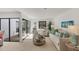 Bright living room with neutral carpet, stylish decor, and a sliding glass door at 3919 Glen Oaks Manor Dr, Sarasota, FL 34232
