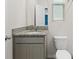 This bathroom features a granite countertop, white toilet, and storage under the sink at 4015 Quiet Rain Ct, Palmetto, FL 34221
