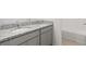 Bathroom featuring double sinks, granite countertops, and white cabinetry at 4015 Quiet Rain Ct, Palmetto, FL 34221