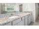 Bathroom with a double sink vanity, granite countertop, and a glass-enclosed shower at 4015 Quiet Rain Ct, Palmetto, FL 34221