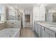 Bright bathroom showcasing double sinks, walk-in shower and soaking tub at 4015 Quiet Rain Ct, Palmetto, FL 34221