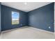 Bedroom with a large window and neutral carpet flooring at 4015 Quiet Rain Ct, Palmetto, FL 34221