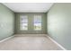 Inviting bedroom with tile flooring and two windows offering ample natural light and painted a refreshing light green tone at 4015 Quiet Rain Ct, Palmetto, FL 34221