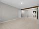 Spacious carpeted bonus room featuring a beam on the ceiling and neutral paint colors at 4015 Quiet Rain Ct, Palmetto, FL 34221