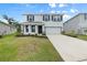 Charming two-story home featuring a well-maintained lawn, covered porch, attached two-car garage, and contrasting dark shutters at 4015 Quiet Rain Ct, Palmetto, FL 34221