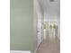 Bright hallway with neutral tile flooring leading to an open living area filled with natural light at 4015 Quiet Rain Ct, Palmetto, FL 34221