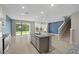 Open kitchen and living area with granite island and stainless-steel appliances at 4015 Quiet Rain Ct, Palmetto, FL 34221