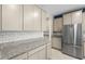 Kitchen featuring granite counters, white subway tile backsplash, and stainless-steel refrigerator at 4015 Quiet Rain Ct, Palmetto, FL 34221