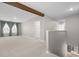 Open living room with exposed beam, large windows, and neutral carpet at 4015 Quiet Rain Ct, Palmetto, FL 34221