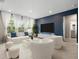 Cozy living room with stylish furniture, a large TV, and bright windows at 4015 Quiet Rain Ct, Palmetto, FL 34221