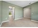 Spacious living area with tile flooring, light green walls, and open doorways leading to other rooms at 4015 Quiet Rain Ct, Palmetto, FL 34221