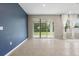 Bright living room with sliding glass doors, tile flooring and ample natural light at 4015 Quiet Rain Ct, Palmetto, FL 34221