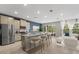 Open-concept living space with kitchen island, dining area, and cozy seating arrangement at 4015 Quiet Rain Ct, Palmetto, FL 34221