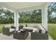 Furnished covered patio offers an outdoor seating area with views of grassy lawn at 4015 Quiet Rain Ct, Palmetto, FL 34221