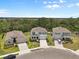 Picturesque street view showcasing three modern homes with well-manicured lawns, driveways, and complementary landscaping at 4015 Quiet Rain Ct, Palmetto, FL 34221