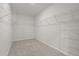 Walk-in closet with carpet flooring and multiple shelves for organization at 4015 Quiet Rain Ct, Palmetto, FL 34221