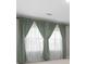 Window treatments with stylish curtain panels and sheer drapes at 4015 Quiet Rain Ct, Palmetto, FL 34221