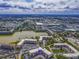 Panoramic aerial view of the condo community showcasing lush surroundings and lakeside setting at 4189 Heron Way # 406E, Bradenton, FL 34205