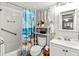 Cozy bathroom features a shower with stylish curtain, toilet, and a vanity with bright lighting at 4189 Heron Way # 406E, Bradenton, FL 34205