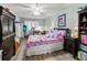 Cozy bedroom with a ceiling fan, warm wood flooring, and a charming quilt at 4189 Heron Way # 406E, Bradenton, FL 34205