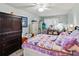 Inviting bedroom with wood floors, a ceiling fan, and a peaceful light green color scheme at 4189 Heron Way # 406E, Bradenton, FL 34205