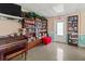 Community room with several bookshelves, a piano, and an exit door at 4189 Heron Way # 406E, Bradenton, FL 34205