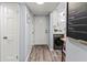 Light and bright entryway featuring plank flooring, a storage area, and convenient laundry at 4189 Heron Way # 406E, Bradenton, FL 34205