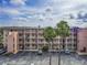 Condo building exterior with lush landscaping, ample parking, and a charming residential setting at 4189 Heron Way # 406E, Bradenton, FL 34205