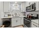 Well-lit kitchen featuring white cabinets, modern appliances, and durable countertops at 4189 Heron Way # 406E, Bradenton, FL 34205