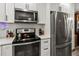 Modern kitchen featuring stainless steel appliances, white cabinets, and sleek countertops at 4189 Heron Way # 406E, Bradenton, FL 34205