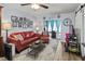 Comfortable living room with a sofa, decorative wall art, and a ceiling fan at 4189 Heron Way # 406E, Bradenton, FL 34205