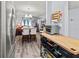 Open-concept living area with dining table and a modern oven at 4189 Heron Way # 406E, Bradenton, FL 34205